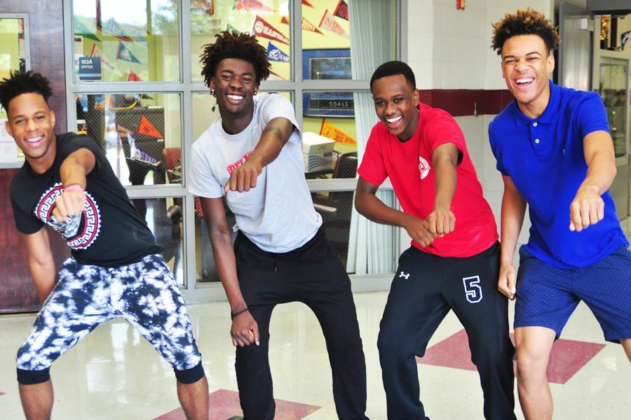 Four students "whip" in the hallway.